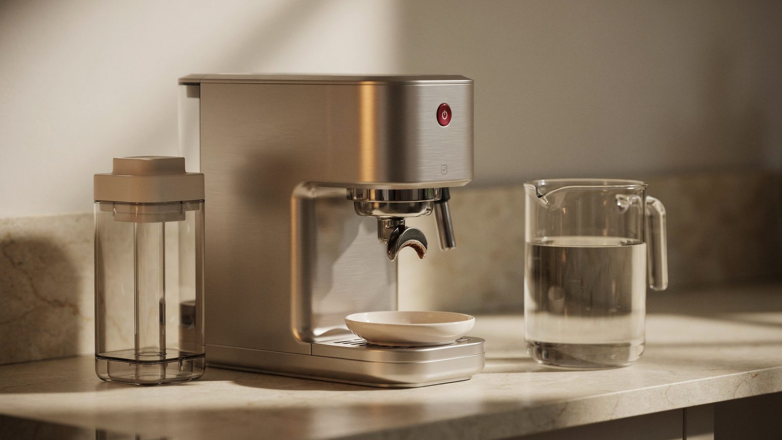 A brushed stainless home espresso machine on a kitchen counter with its water tank removed and set beside it, a measuring jug of clear water and a small empty white bowl under the group head, tidy mai